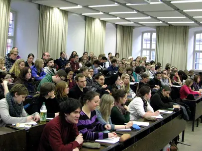 Photo of Dr. Marcia Pally giving her talk and attendees listening to her.